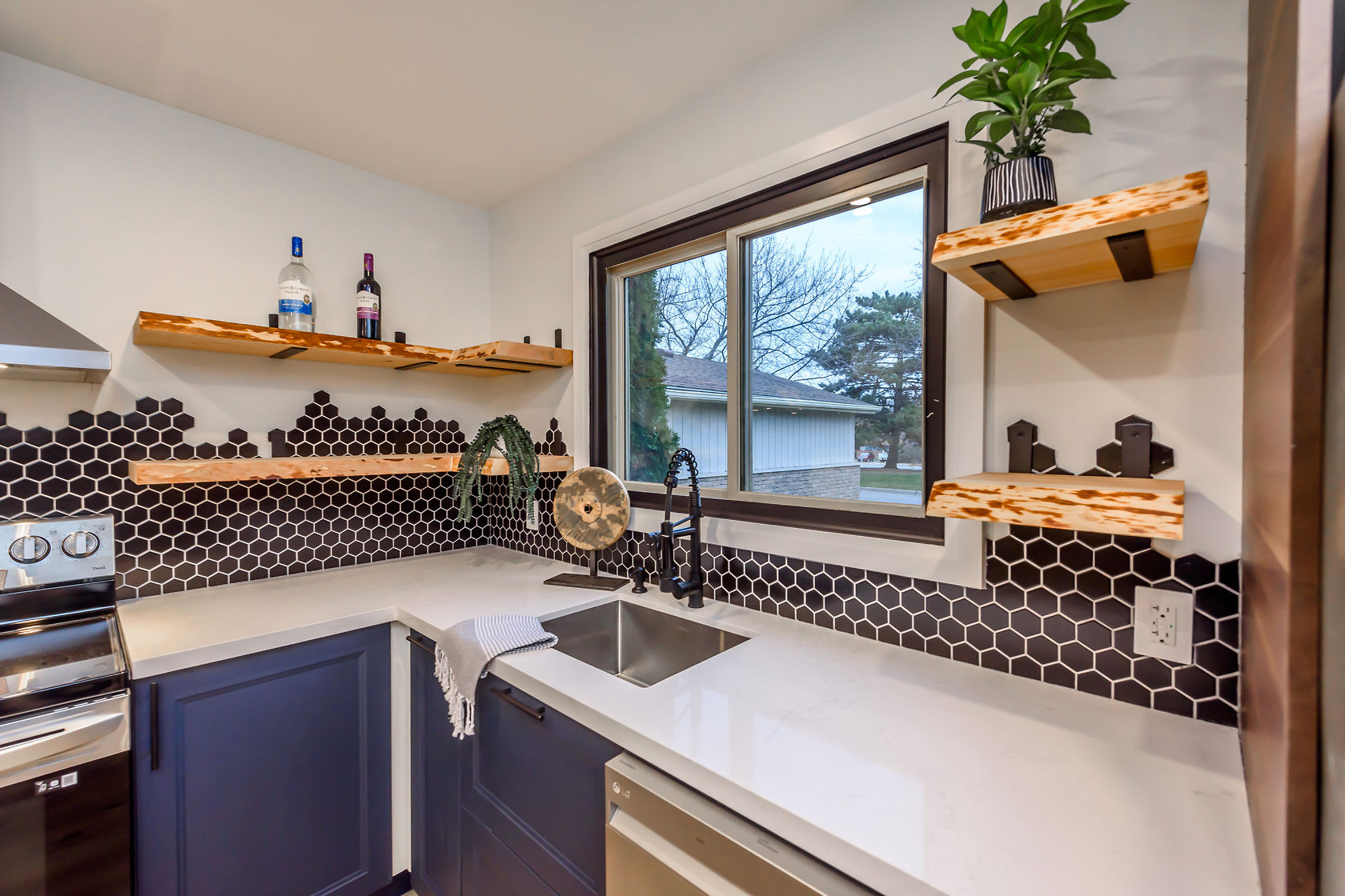 Stunning finished kitchen with dramatic black hexagon backsplash, floating wood shelves, and excellent natural light — premium portfolio shot — Gateshead, Hamilton | MTC Renovations